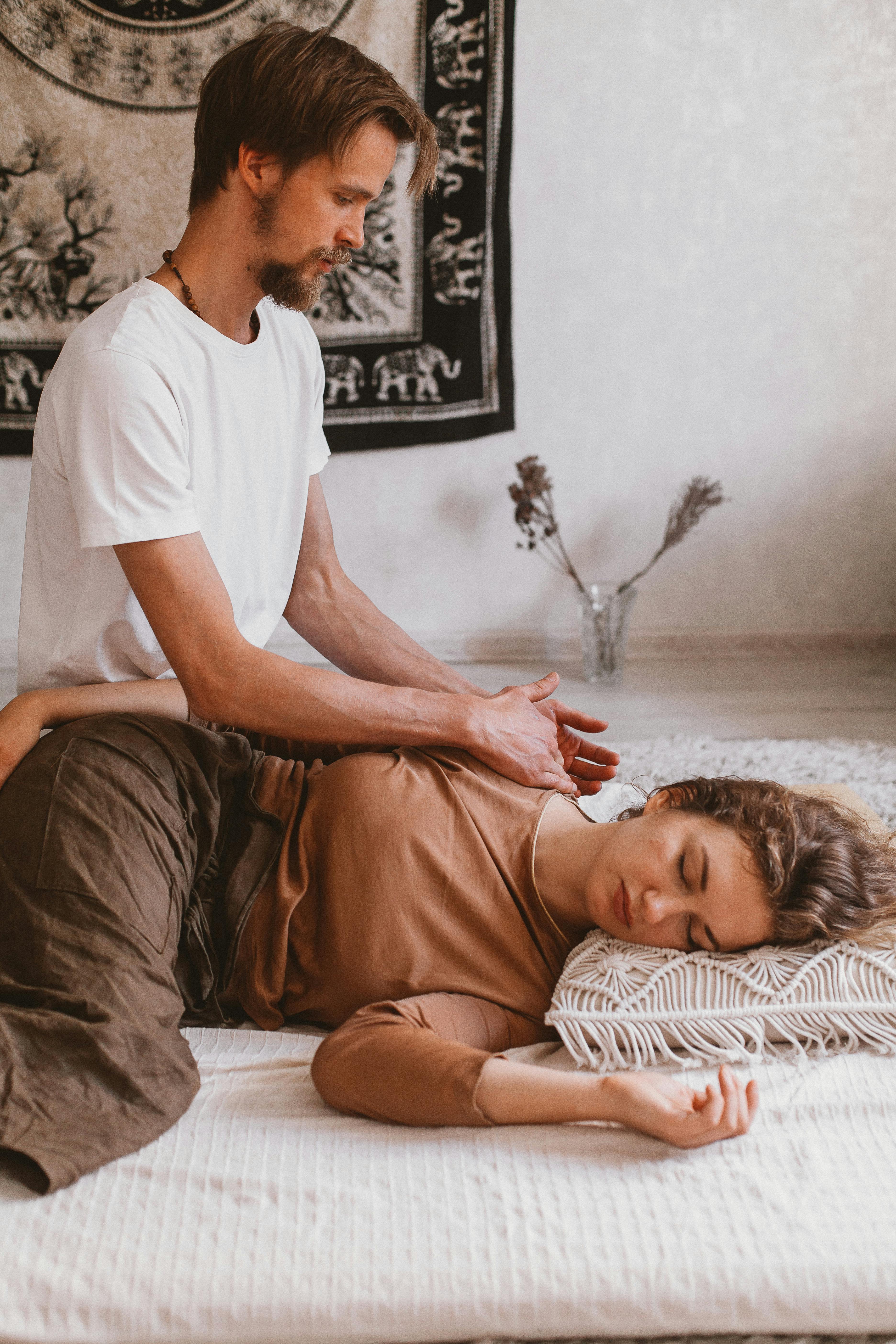 A serene setting for a tantric massage with calming candles and soft lighting.