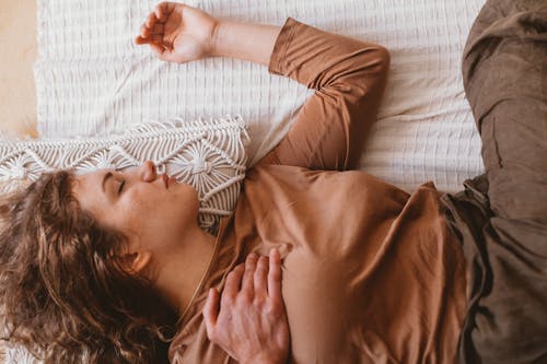 A Woman Sleeping on the Bed 