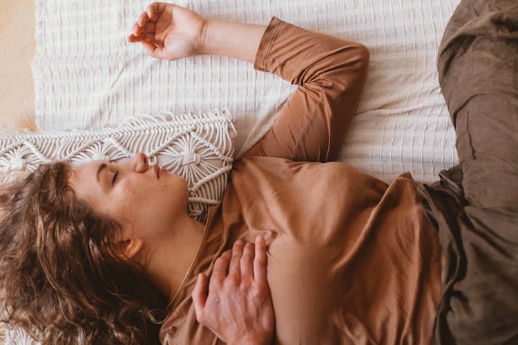 A Woman Sleeping On The Bed 