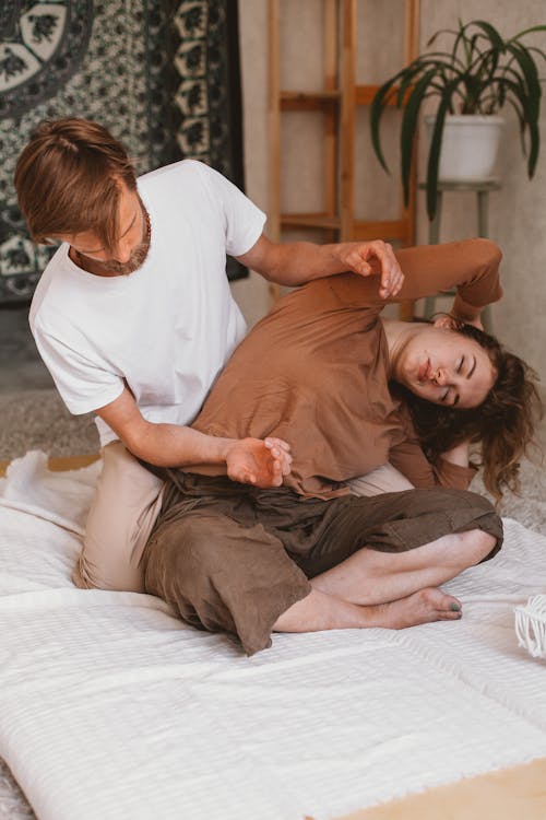 Man Sitting and Doing Massage to Woman 