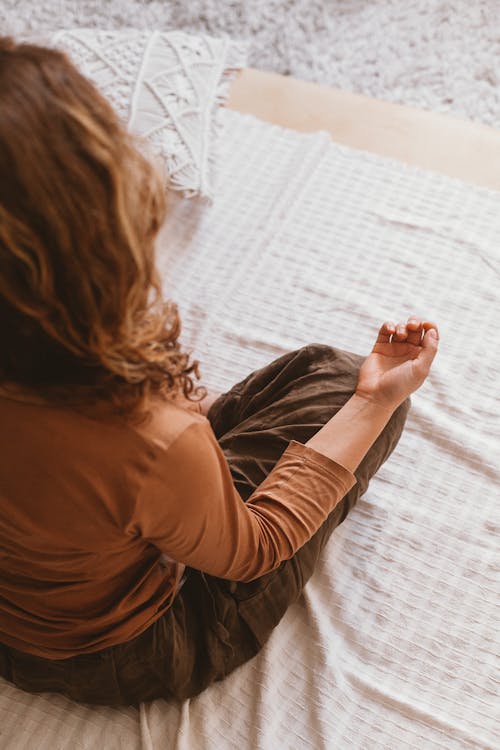 Woman in Brown Long Sleeves Meditating