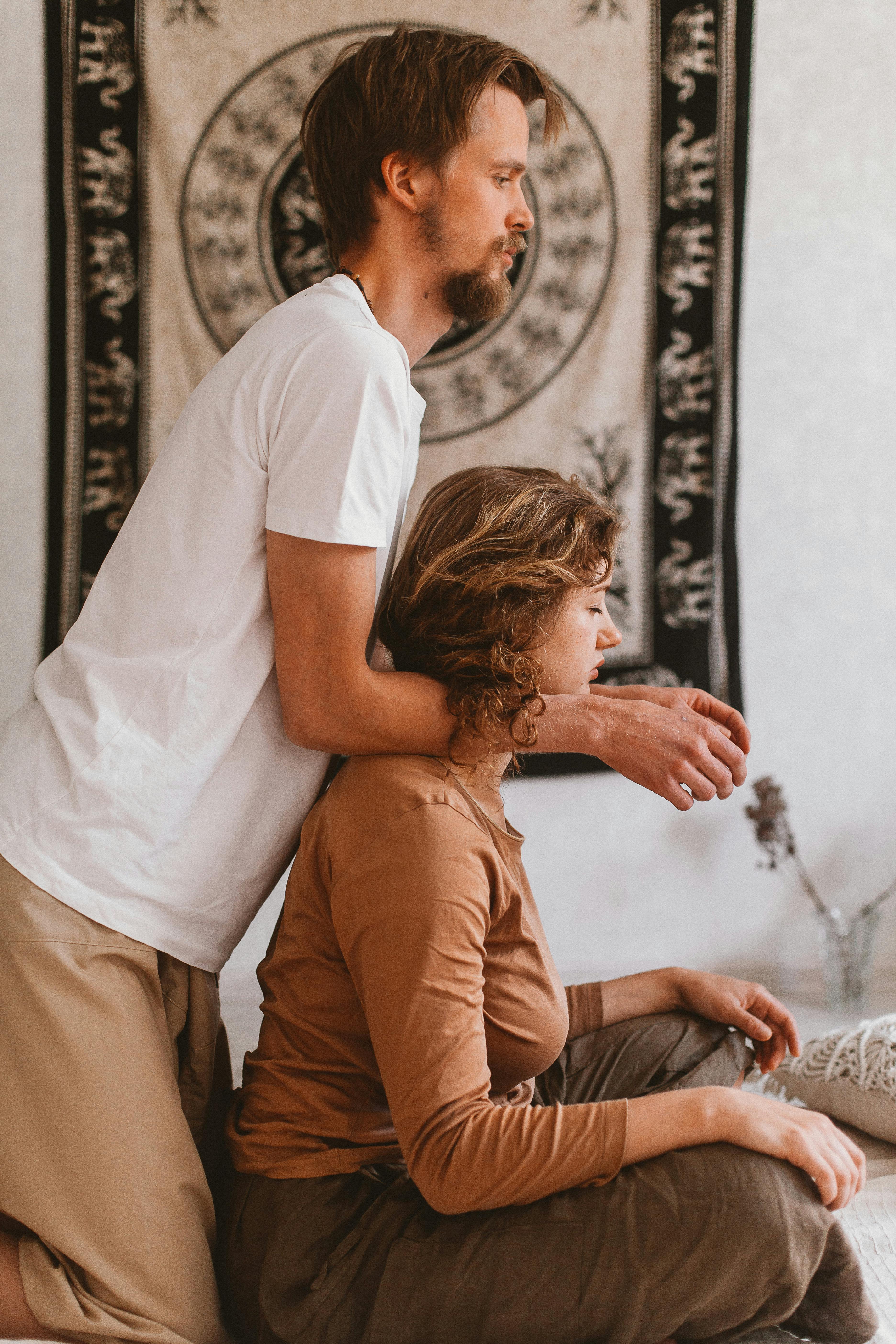 man holding arms on woman