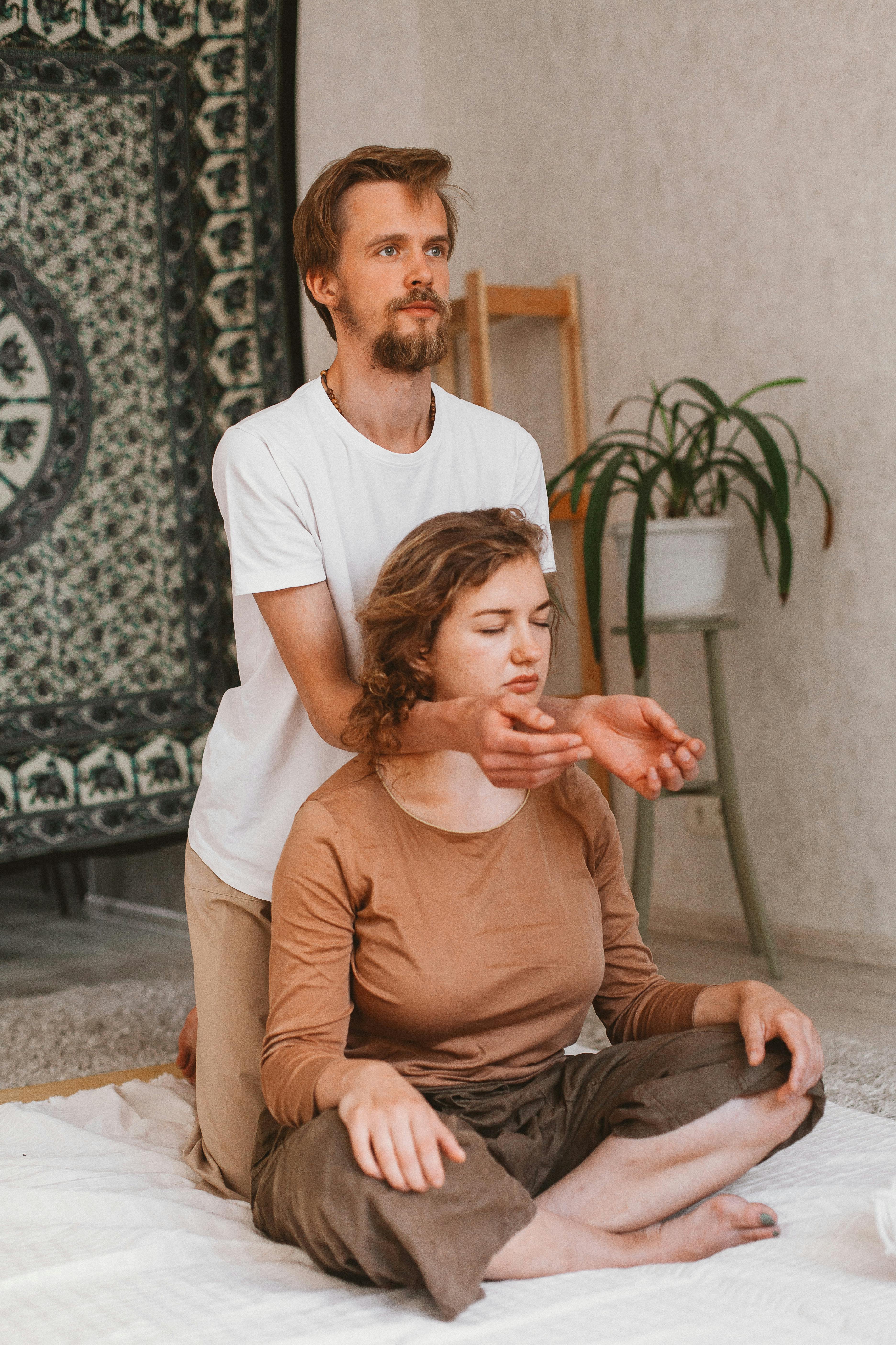 man holding arms on sitting woman