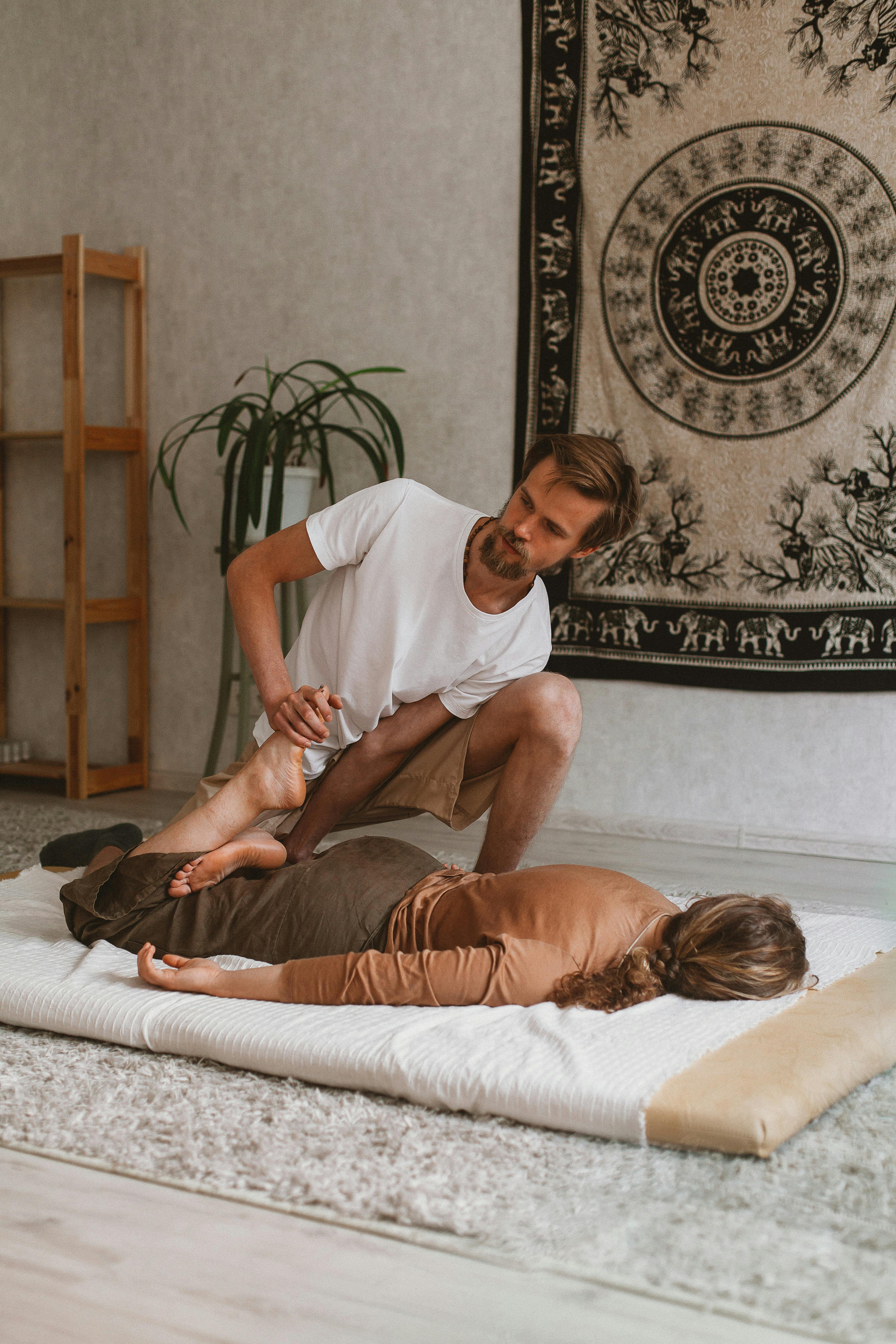 man doing massage to woman legs