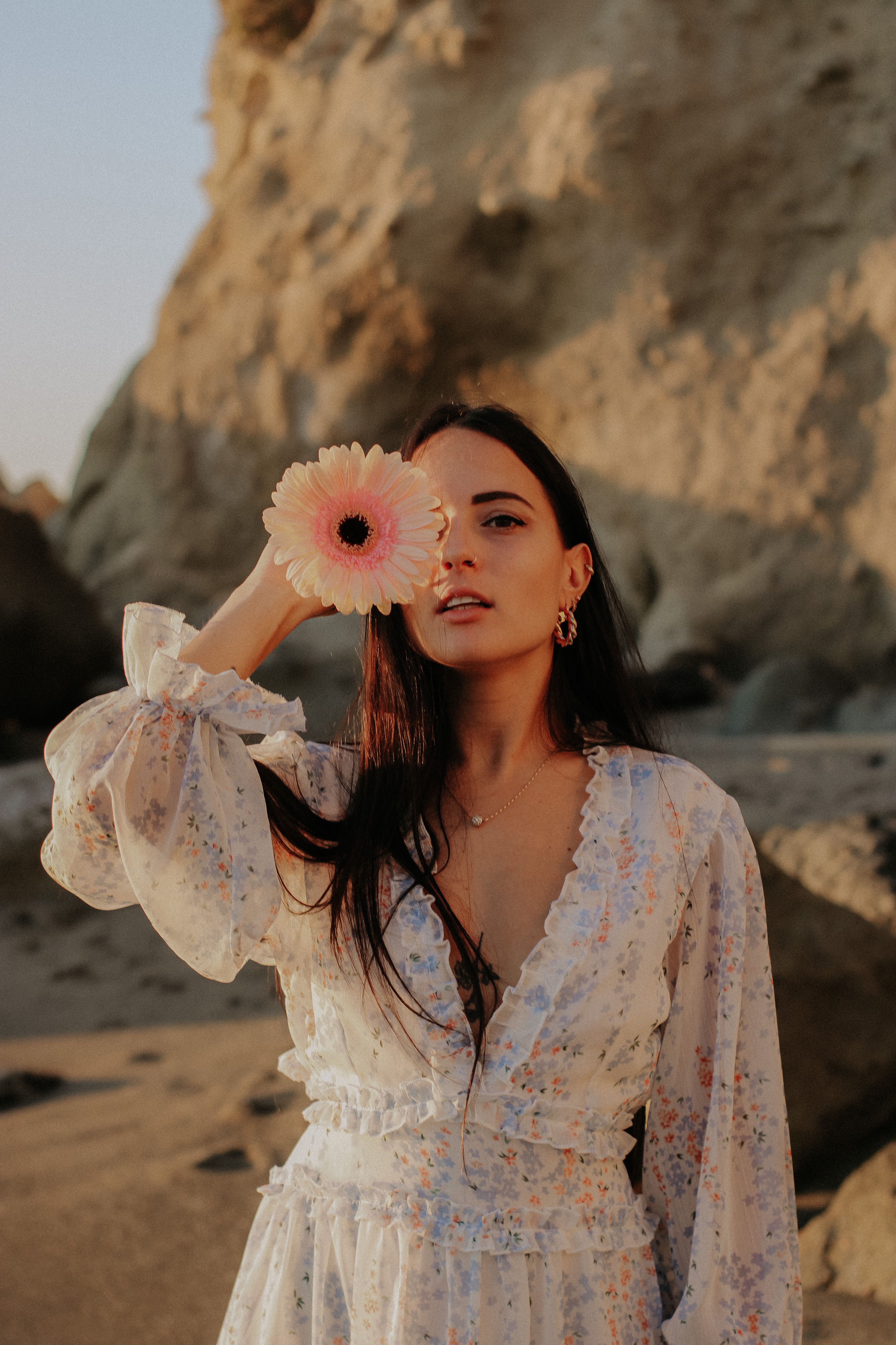 Woman in White Floral Dress Holding Pink Flower · Free Stock Photo