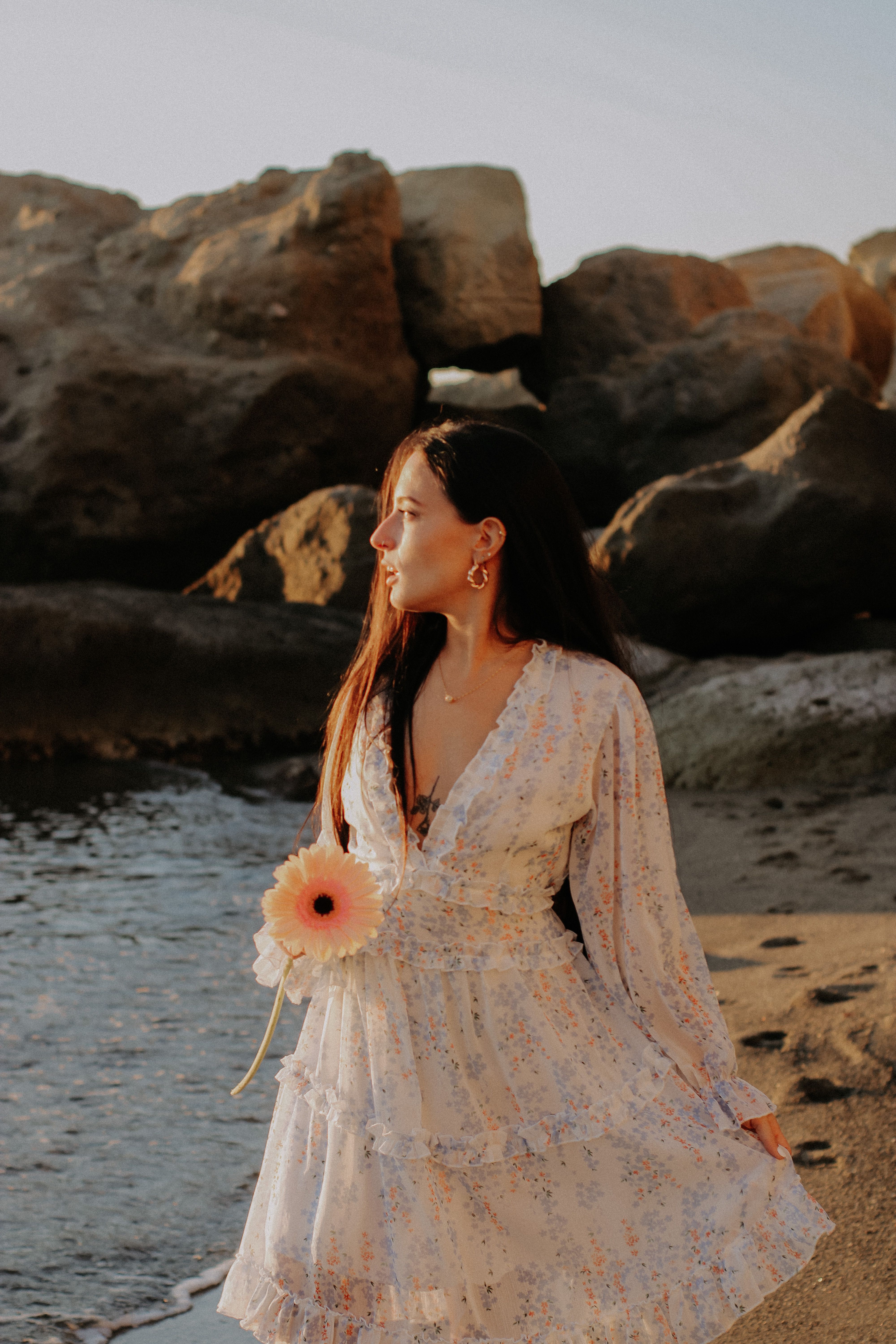 A Woman in Floral Dress Standing on the Shore · Free Stock Photo
