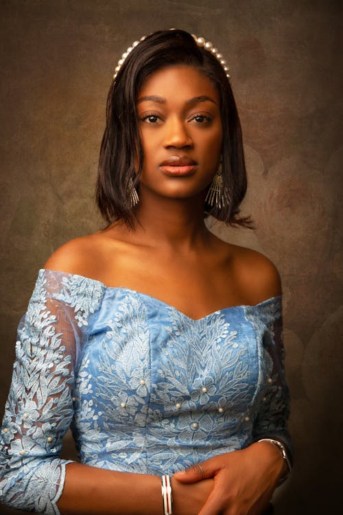 Woman in Blue Off Shoulder Dress Posing