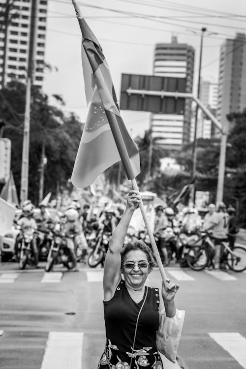 Grayscale Photo of Woman Holding Flag