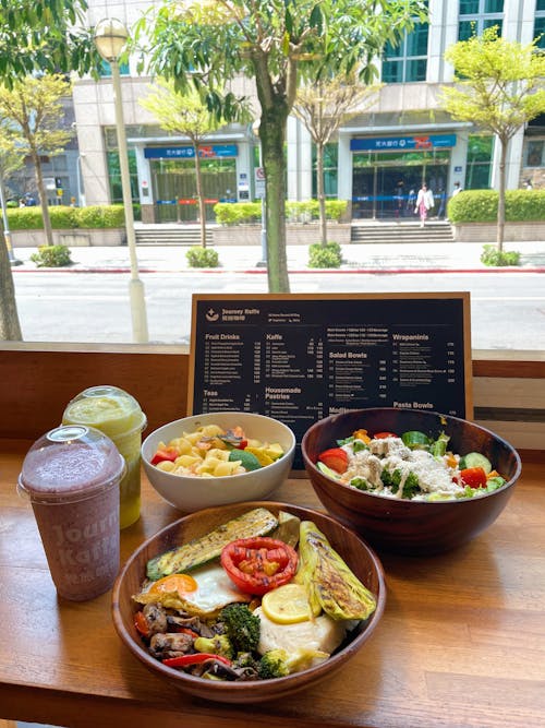 Fruit Salad and Smoothies with a Restaurant Menu on the Table 