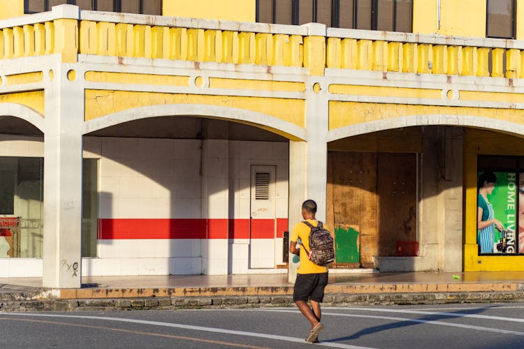 A Man With Backpack Walking Outside