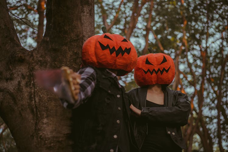 Two People Wearing Pumpkin Masks