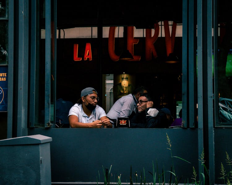 Men Sitting In A Bar By The Window 