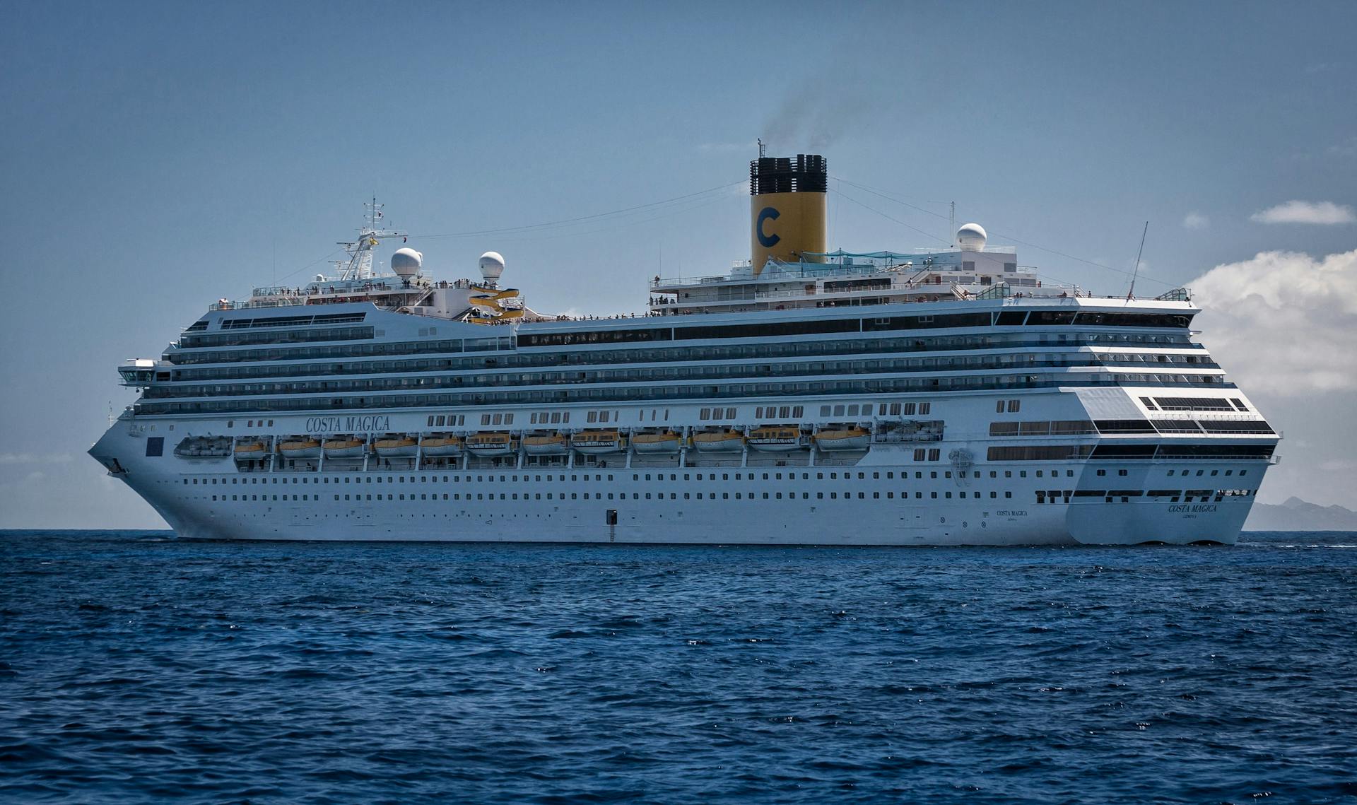 A majestic cruise ship sails through the vast ocean, symbolizing travel and adventure.
