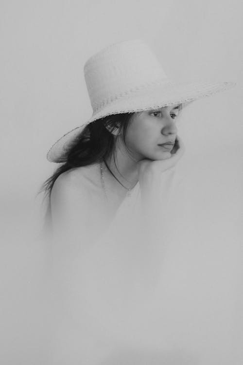 Black and White Photo of Woman Wearing a Hat