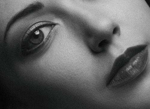 Free Artistic close-up black and white portrait showing the details of a woman's eye, nose, and lips. Stock Photo