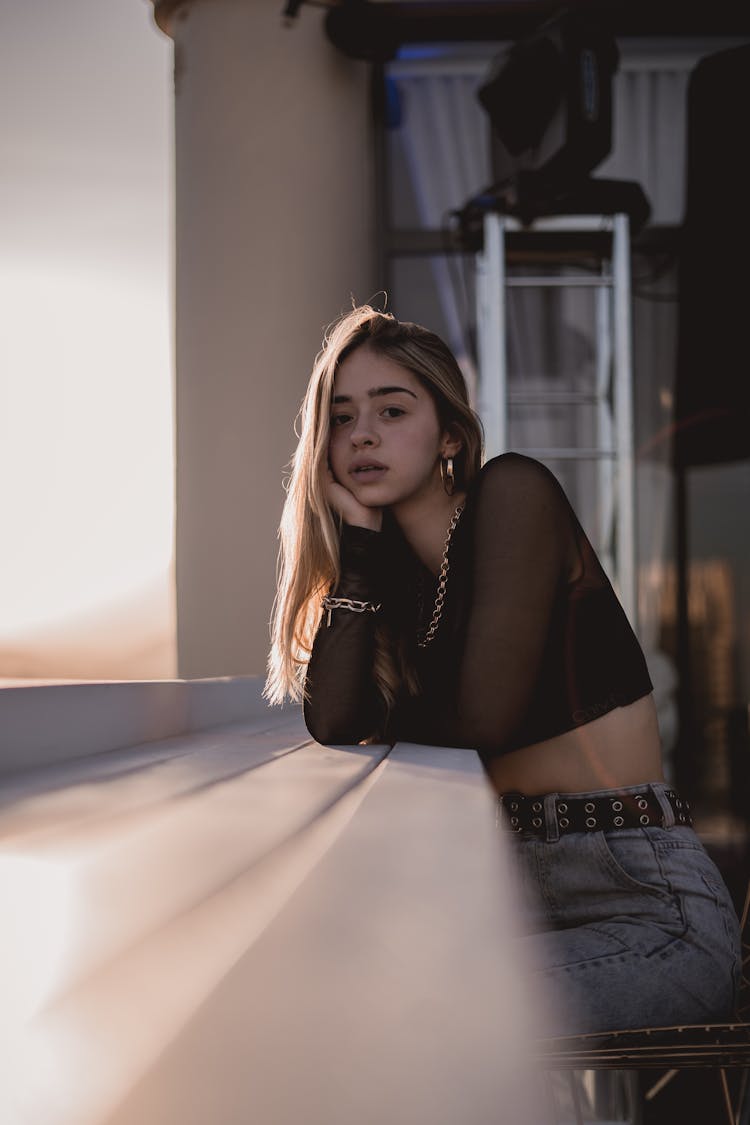 Sitting Girl Leaning On A Counter