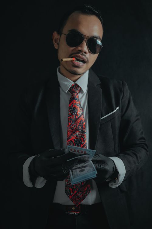 Free Stylish man in sunglasses counting cash with a cigarette. Stock Photo