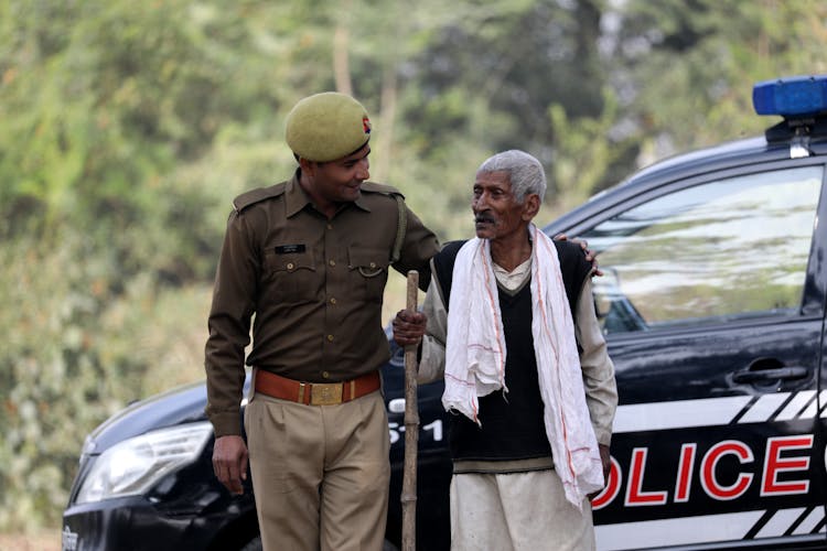 A Police Officer Talking To An Elderly Man