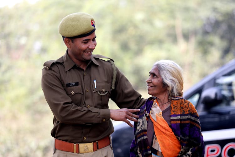 Police Officer Helping An Elderly Woman 