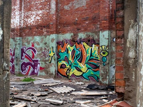 Free Vibrant graffiti art on a damaged brick wall of an abandoned building in Durban, South Africa. Stock Photo