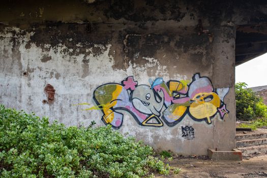 Colorful graffiti adorns a concrete wall under a bridge in Durban, South Africa.