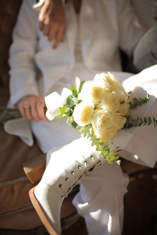 Person Holding White Roses in Hand