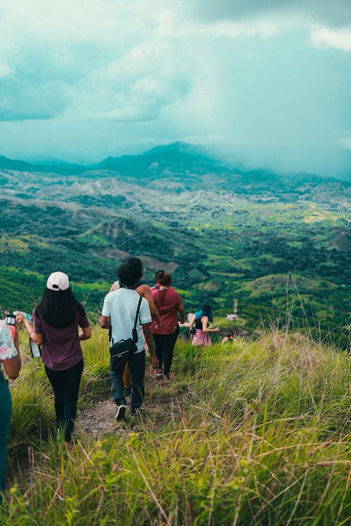 People Walking down a Mountain