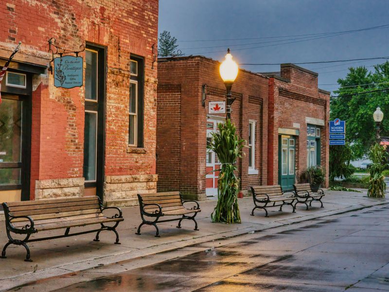 Historic small-town main street with brick storefronts and benches