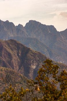 Scenic view of rugged mountains with autumn foliage, a perfect nature travel destination.