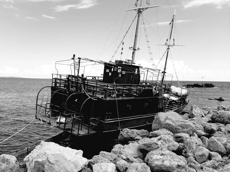 Black And White Photo Of A Moored Ship 