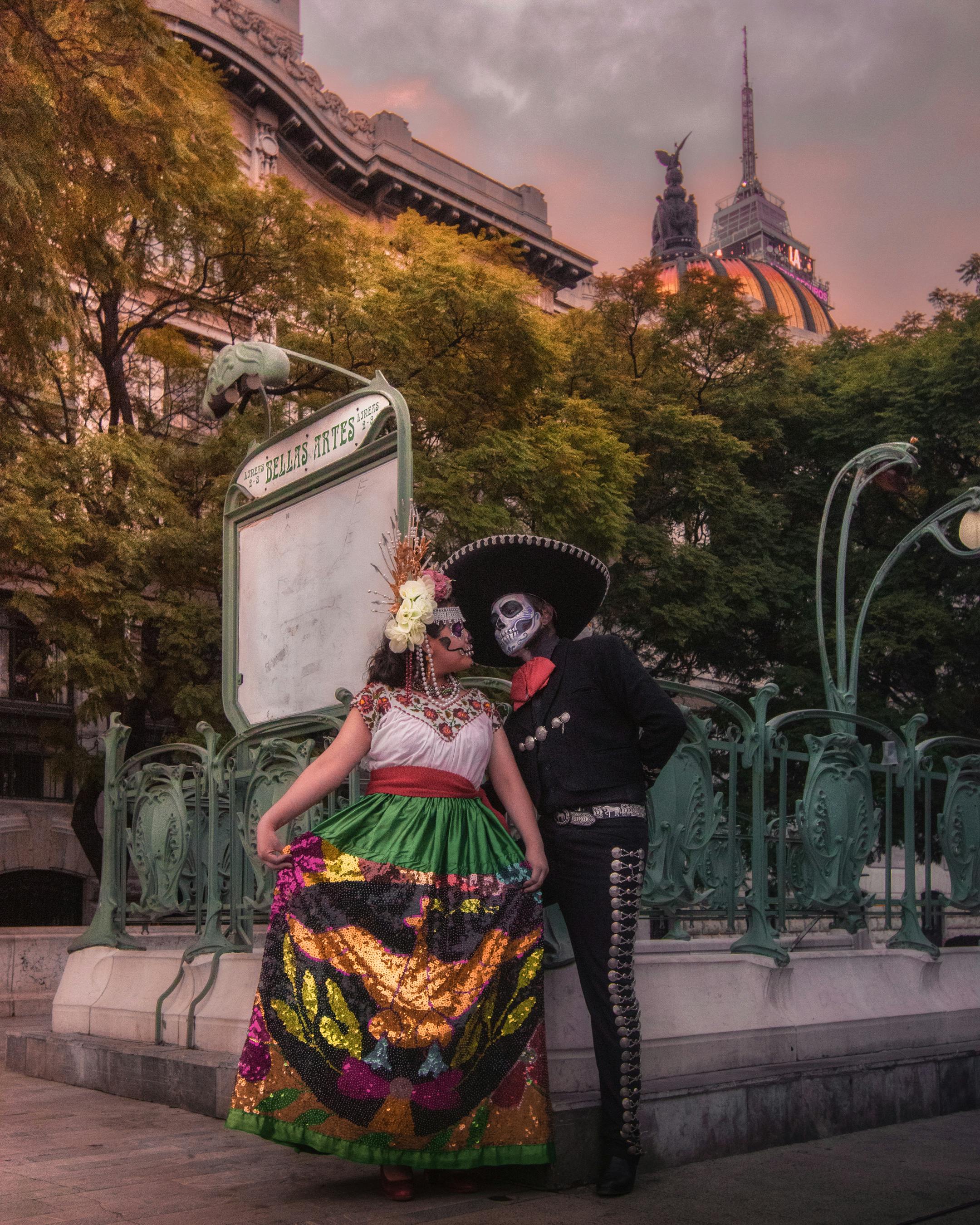 a couple wearing costumes while standing on the street