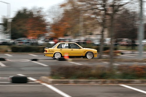 Yellow Racing Car Driving on a Parking Lot