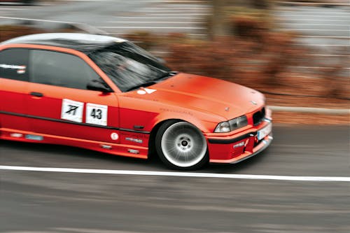 Free Red Racecar Driving Fast Stock Photo