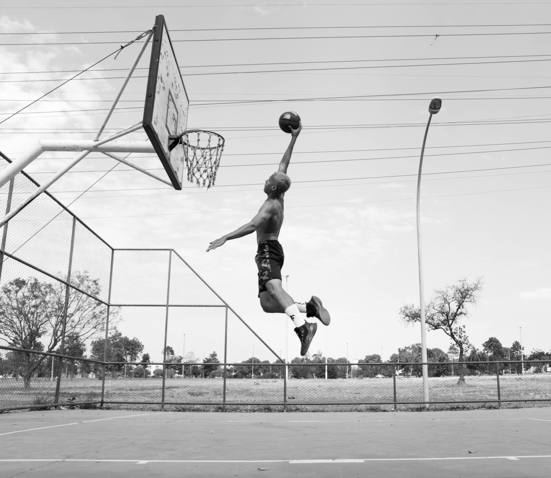 Dynamic Action Photo of Man Playing Basketball