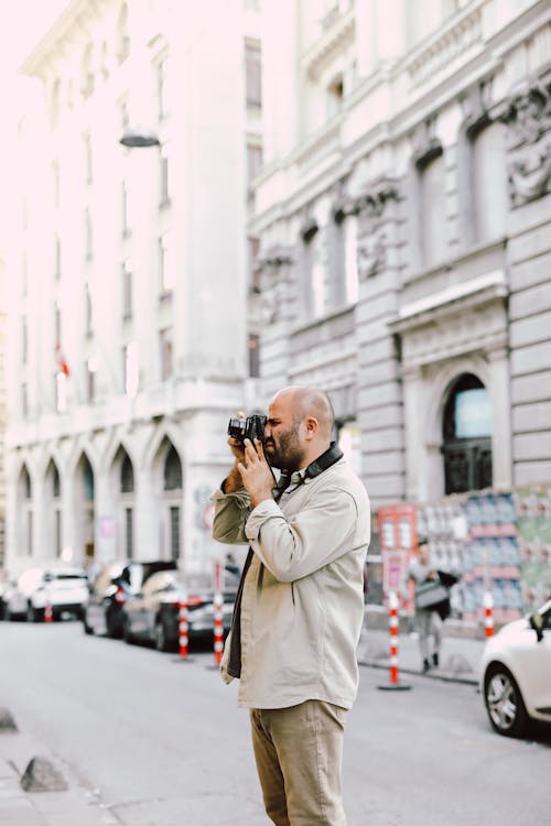 Bald Man Taking Photo with a Camera