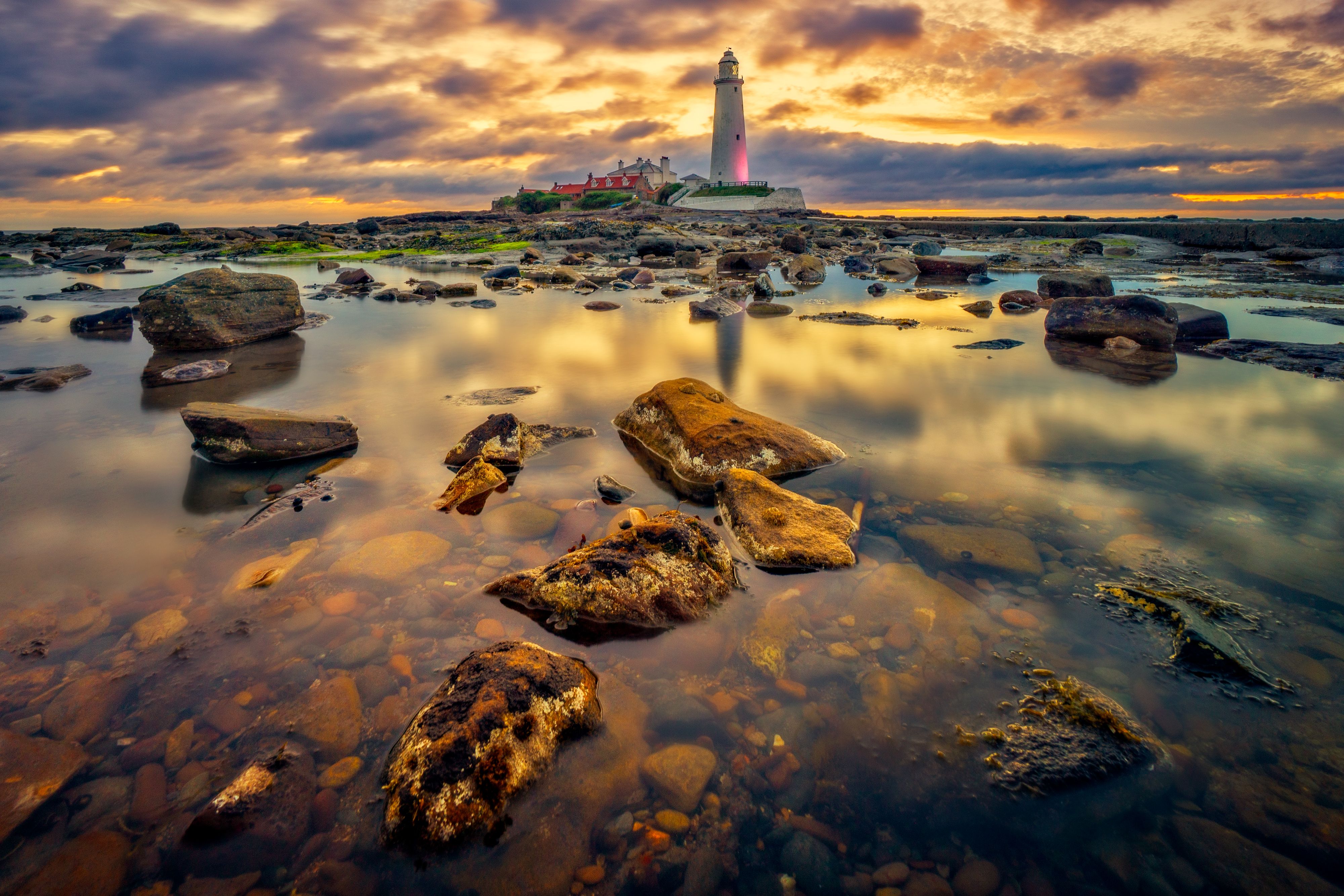 White and Red Lighthouse Near Body of Water Under Cloudy Sky · Free ...