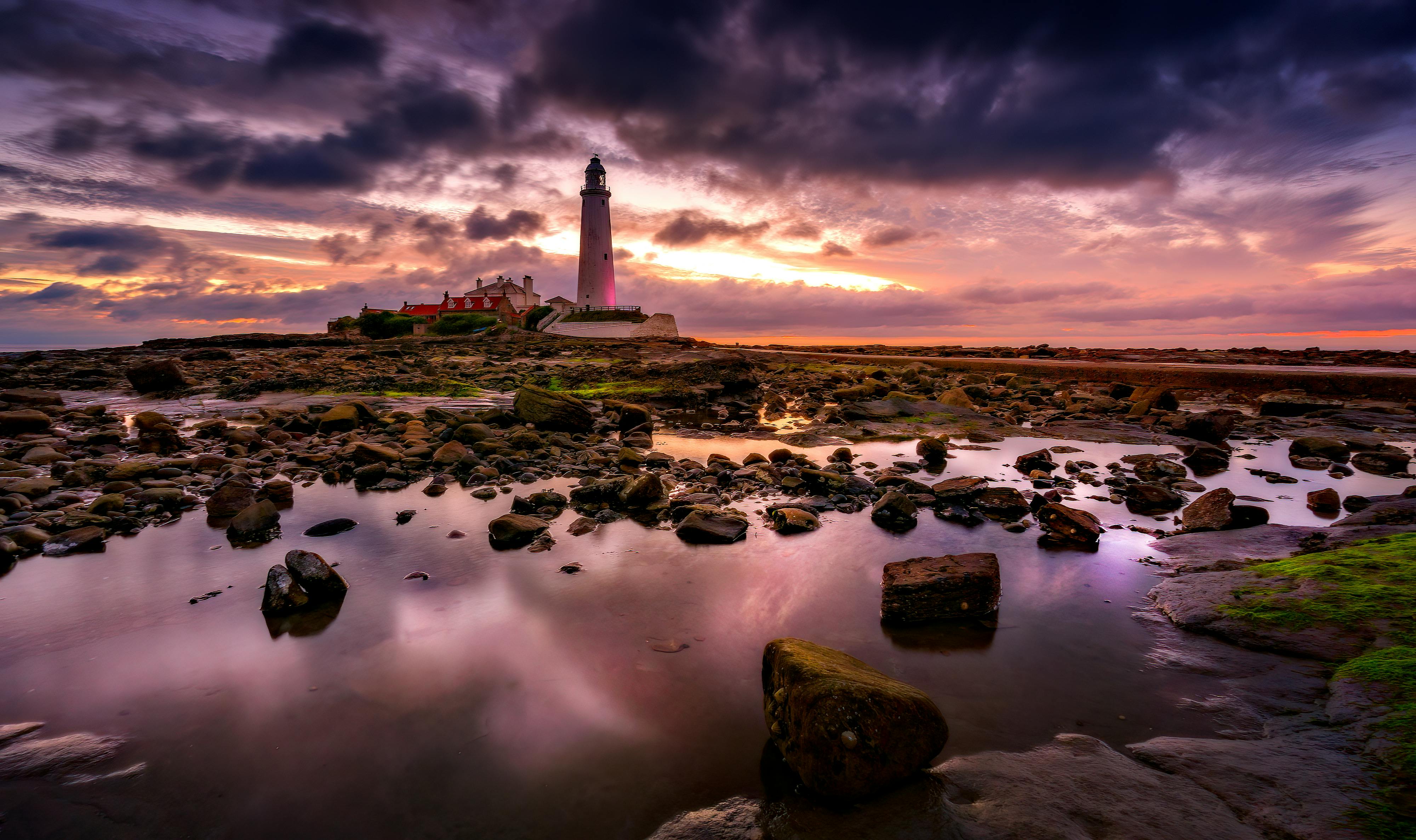 White And Black Lighthouse On Rocky Shore Under Cloudy Sky · Free Stock ...