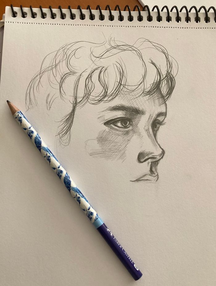 Detailed pencil portrait drawn on white sketchbook paper