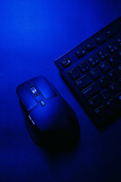 Close-up of a Keyboard and Mouse in Blue Light