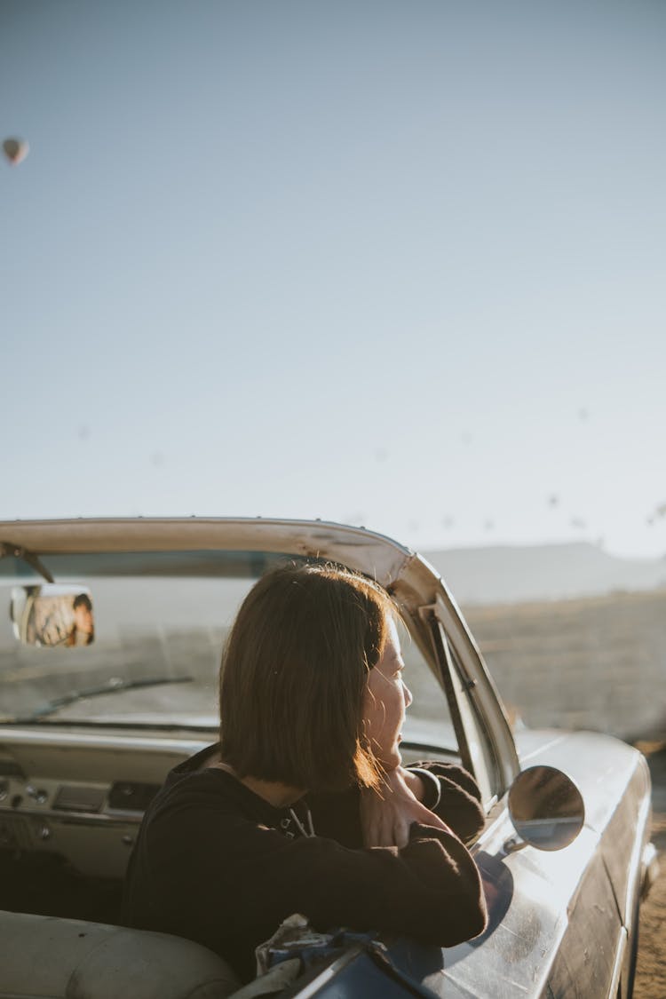 Woman In Black Shirt Sitting On Car Seat