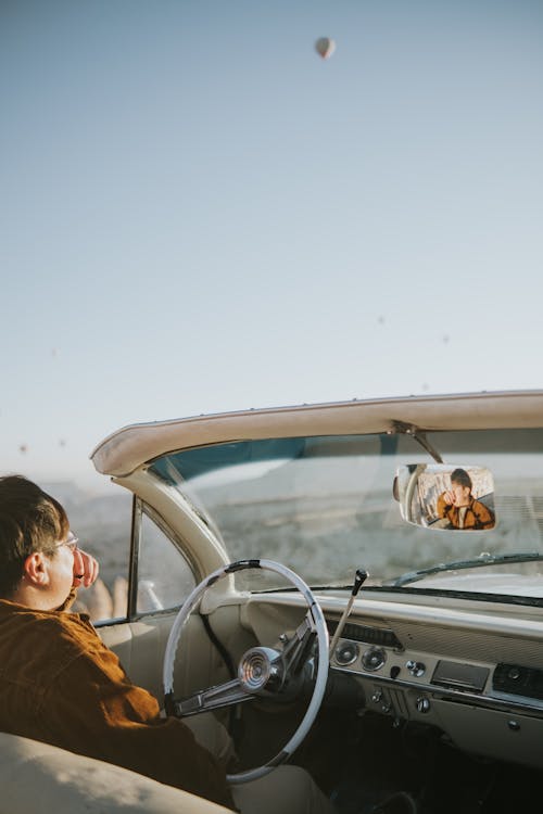 A Person Driving a Convertible Car