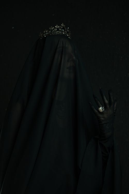 Free A woman shrouded in a black veil and crown, exuding a mysterious and haunting presence. Stock Photo