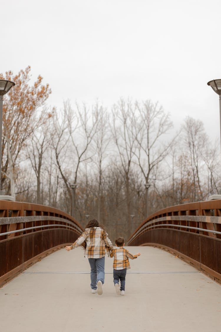 Kids Running On A Wooden Bridge