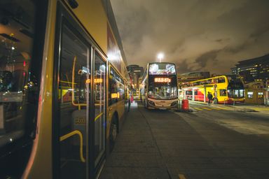 The evening bus waiting at the stop after dark