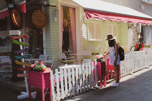 A woman admires flowers outside a charming cafe in Adalar, İstanbul, Turkey.