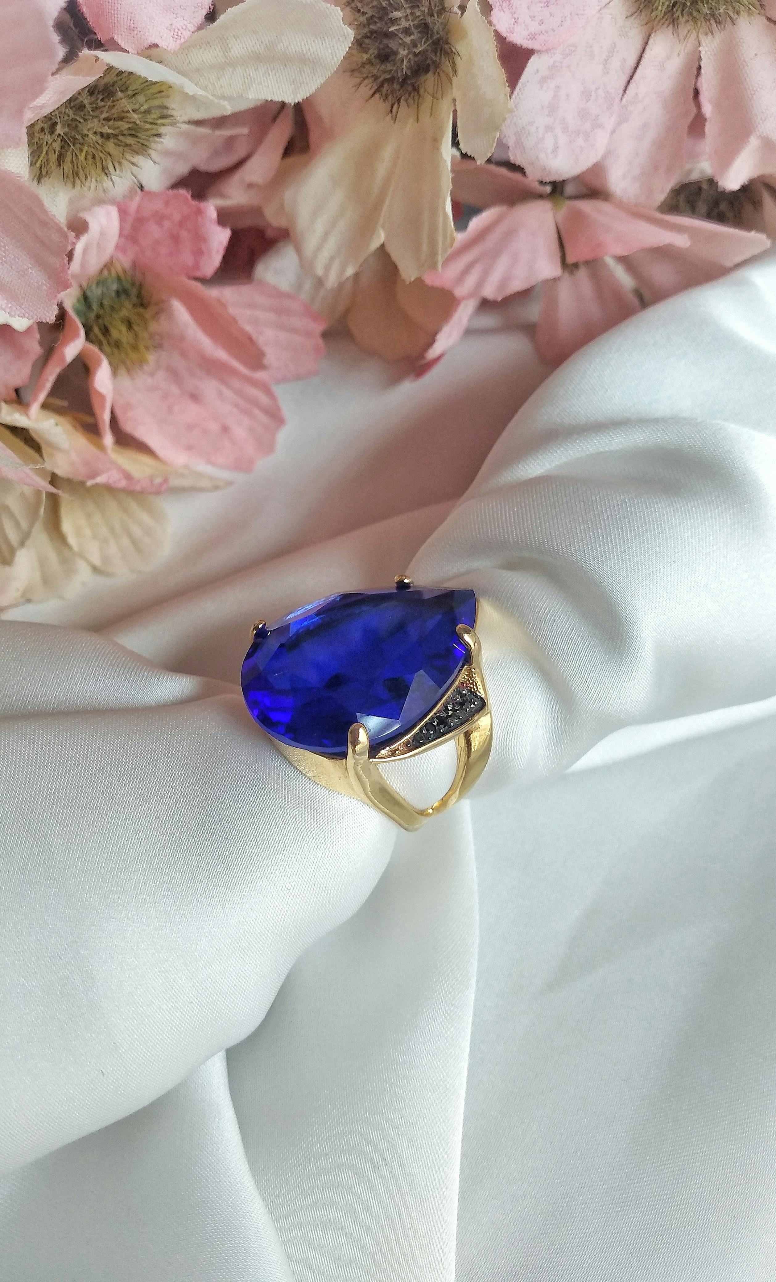 blue gemstone on a gold ring