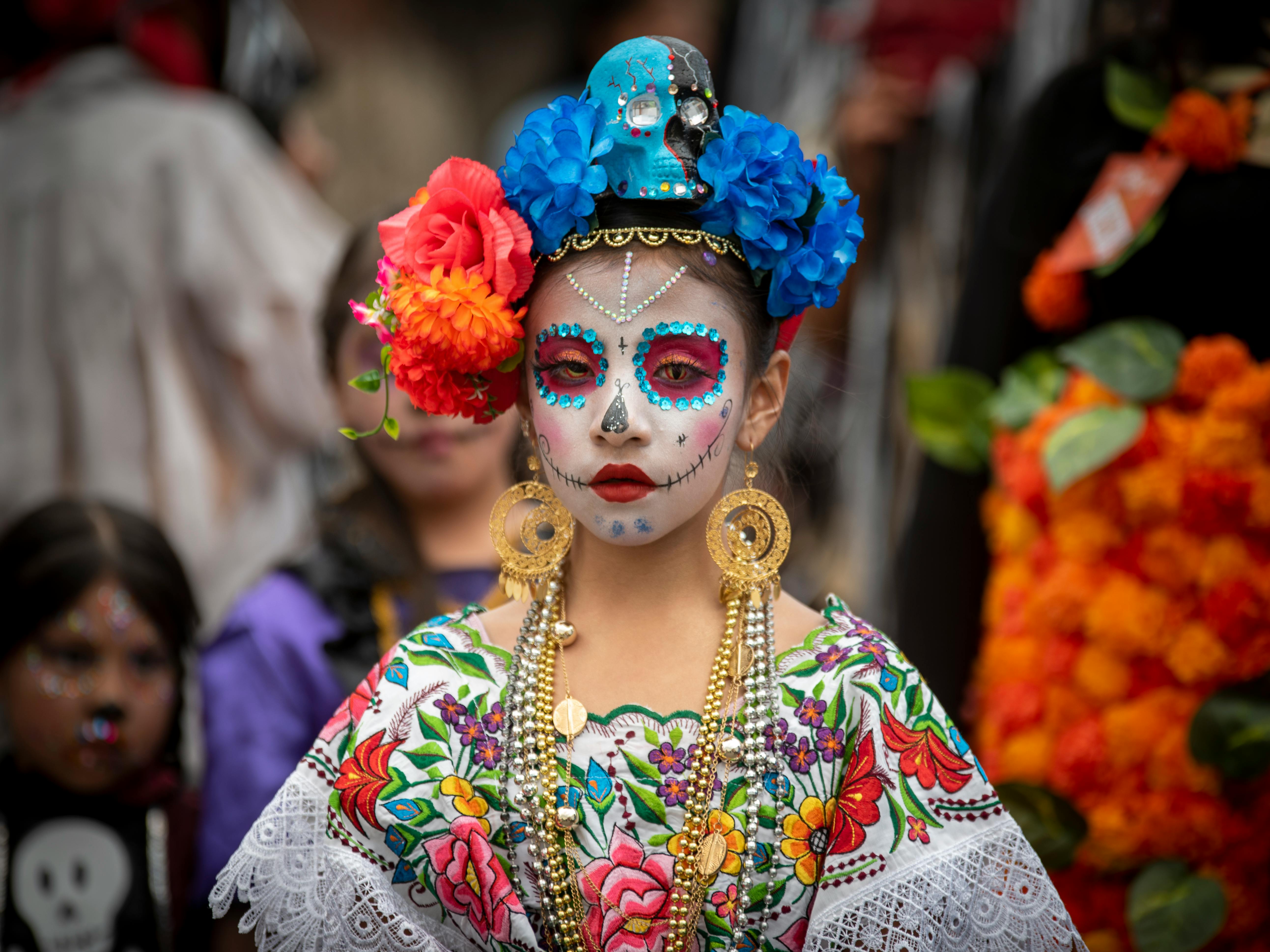 Person With Face Paint Behind Leaves Of A Plant · Free Stock Photo