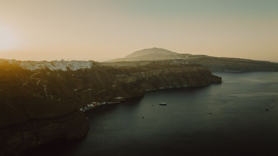 Santorini's white cliffside villages above the blue Aegean sea