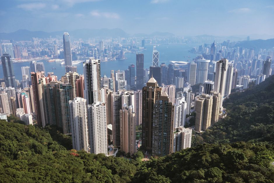 Arrancacéus de Hong Kong e Victoria Harbor, simbolizando investimentos imobiliários globais e tributação internacional.