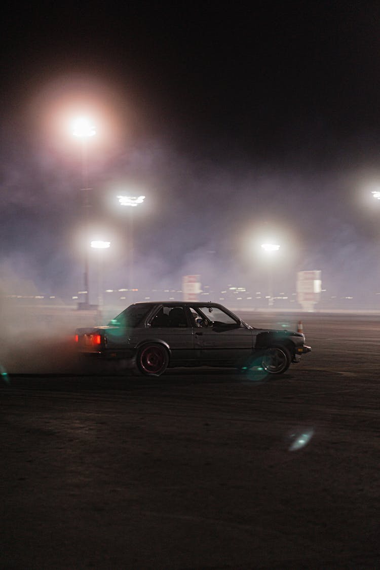 A Black Car On The Road At Night